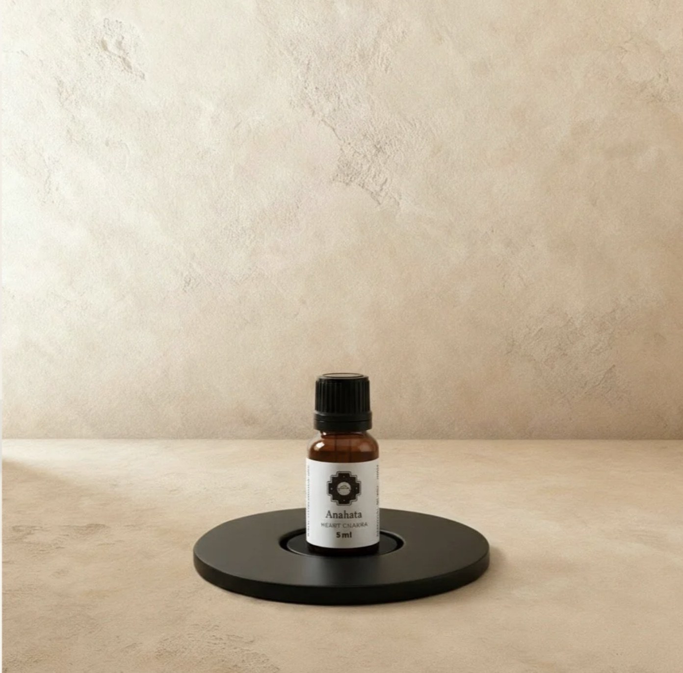 Chaka Anahata heart chakra oil bottle on a black stand