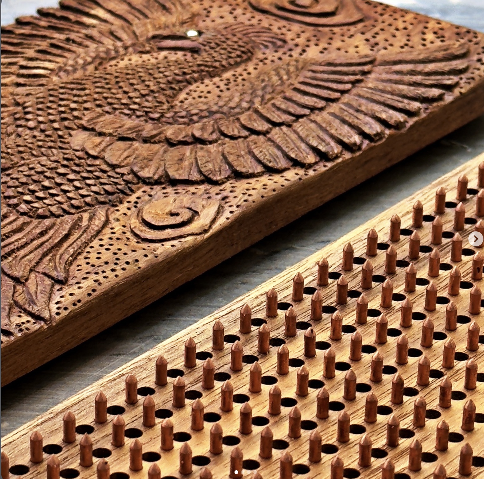 Hand-carved wooden nailboard with copper nails